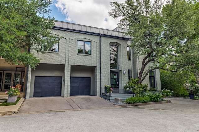 4678 Christopher Pl, Dallas, TX 75204 - view of front facade with a garage, driveway, and brick siding