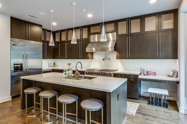 4678 Christopher Pl, Dallas, TX 75204 - kitchen with stainless steel built in fridge, exhaust hood, a sink, wood finished floors, and recessed lighting