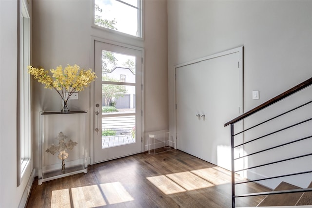 4678 Christopher Pl, Dallas, TX 75204 - foyer entrance featuring wood finished floors, stairs, and a high ceiling