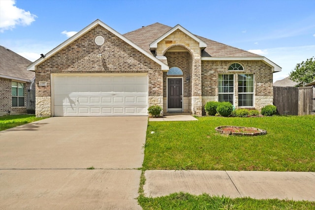 131 Wandering Dr, Forney, TX 75126 - view of front of house featuring brick siding, driveway, an attached garage, and stone siding