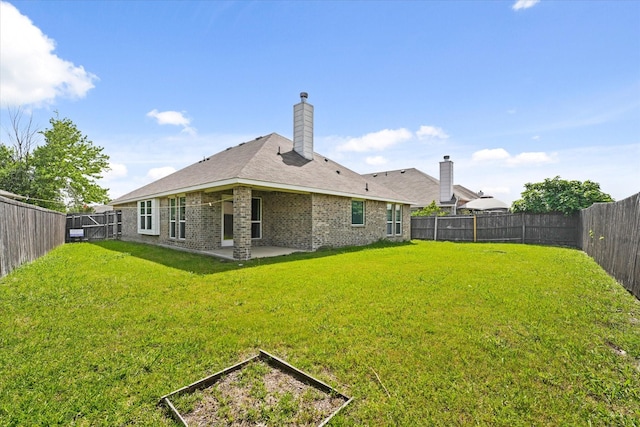 131 Wandering Dr, Forney, TX 75126 - back of property featuring a patio, a chimney, a vegetable garden, and brick siding