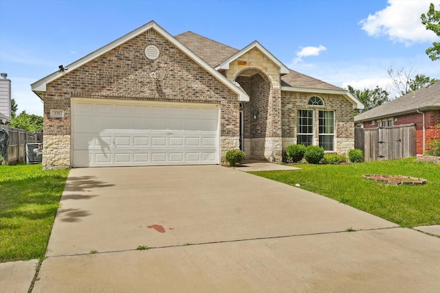 131 Wandering Dr, Forney, TX 75126 - view of front of property with stone siding, concrete driveway, and brick siding