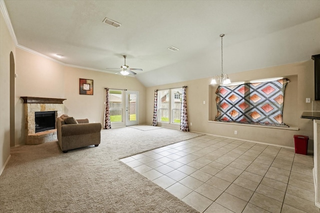 131 Wandering Dr, Forney, TX 75126 - carpeted living room with a ceiling fan, a stone fireplace, tile patterned flooring, arched walkways, and vaulted ceiling