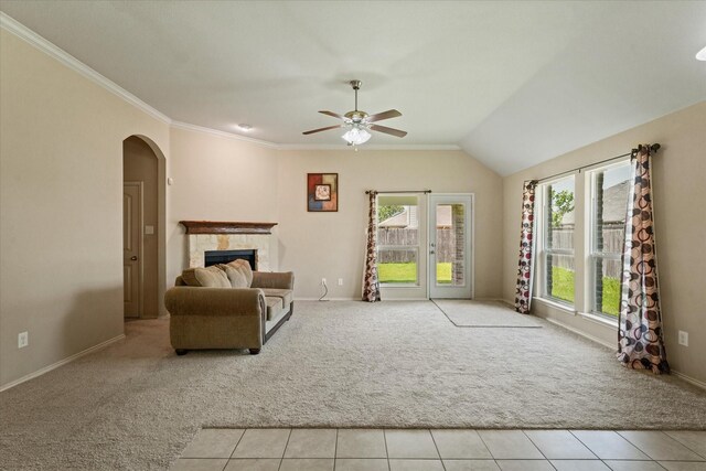 131 Wandering Dr, Forney, TX 75126 - living area featuring light colored carpet, ceiling fan, a fireplace, baseboards, and arched walkways