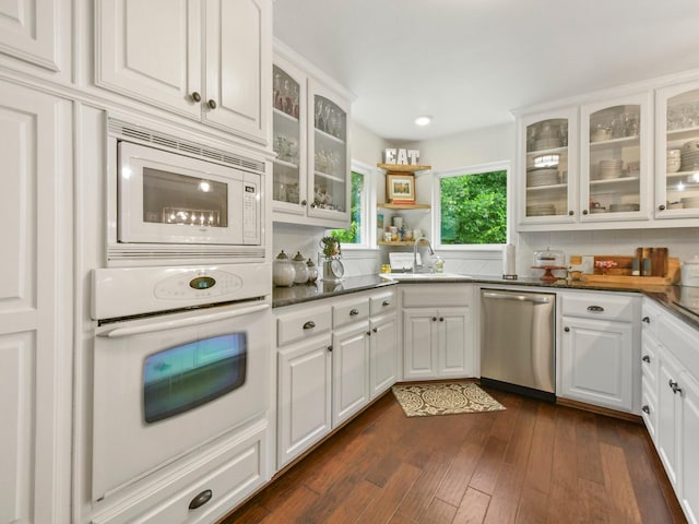1951 Ravenwood Dr, Keller, TX 76262 - kitchen featuring white appliances, a sink, white cabinets, and dark wood-style flooring