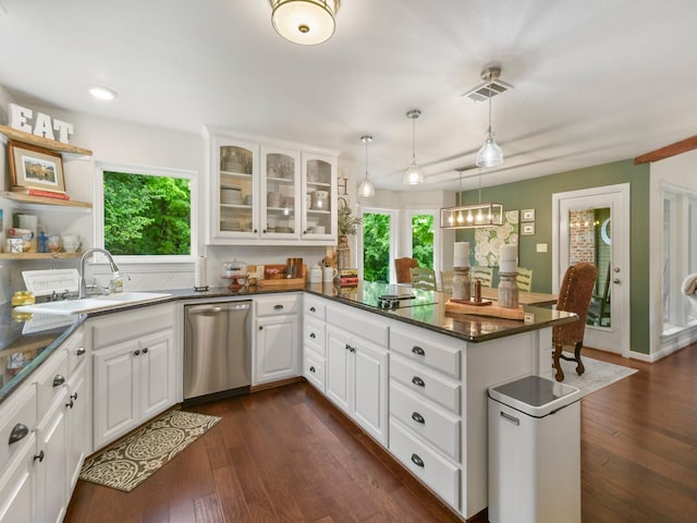 1951 Ravenwood Dr, Keller, TX 76262 - kitchen with stainless steel dishwasher, a sink, a peninsula, and dark wood-style flooring