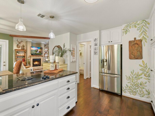 1951 Ravenwood Dr, Keller, TX 76262 - kitchen featuring stainless steel refrigerator with ice dispenser, black electric cooktop, dark stone countertops, dark wood-style flooring, and white cabinets
