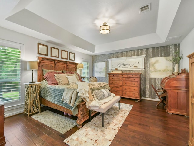 1951 Ravenwood Dr, Keller, TX 76262 - bedroom featuring a raised ceiling, wallpapered walls, dark wood-style floors, and baseboards