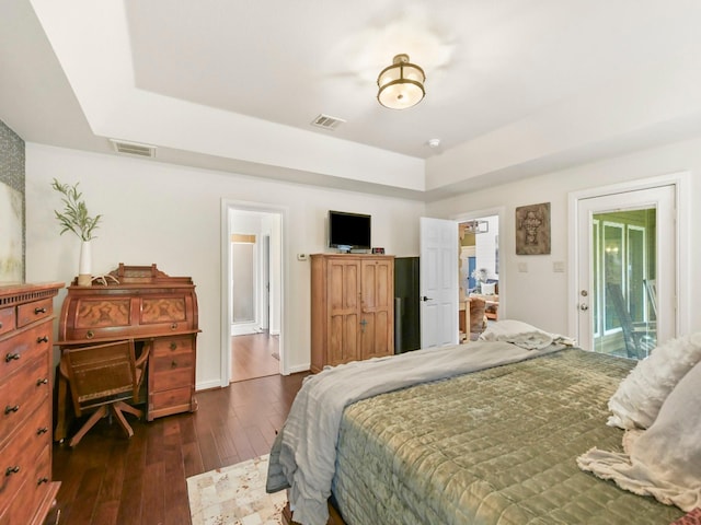 1951 Ravenwood Dr, Keller, TX 76262 - bedroom with dark wood-type flooring, a raised ceiling, and ensuite bathroom