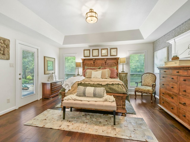 1951 Ravenwood Dr, Keller, TX 76262 - bedroom with a tray ceiling, dark wood finished floors, access to outside, and baseboards