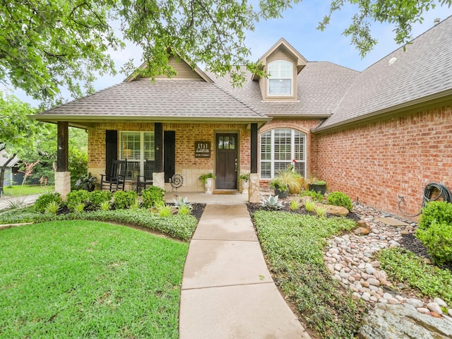 1951 Ravenwood Dr, Keller, TX 76262 - view of front of home with a shingled roof, brick siding, a front yard, and a porch