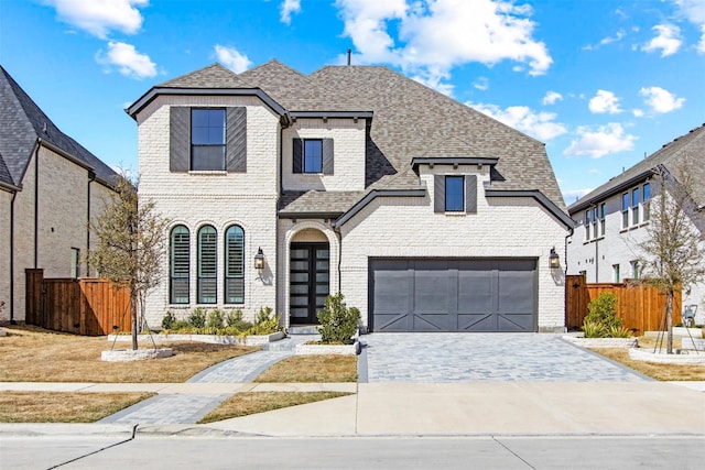 16098 Garganey Ct, Frisco, TX 75035 - french country style house with a garage, a shingled roof, driveway, and brick siding