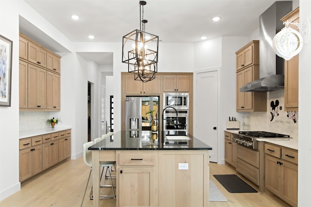 16098 Garganey Ct, Frisco, TX 75035 - kitchen featuring stainless steel appliances, light brown cabinets, wall chimney range hood, light wood finished floors, and recessed lighting
