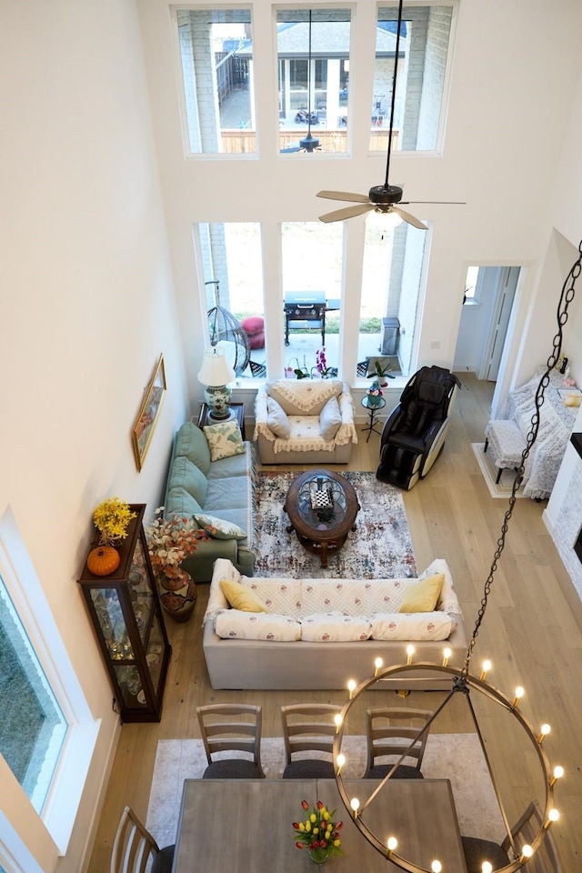 16098 Garganey Ct, Frisco, TX 75035 - living room featuring a high ceiling, wood finished floors, plenty of natural light, and a ceiling fan