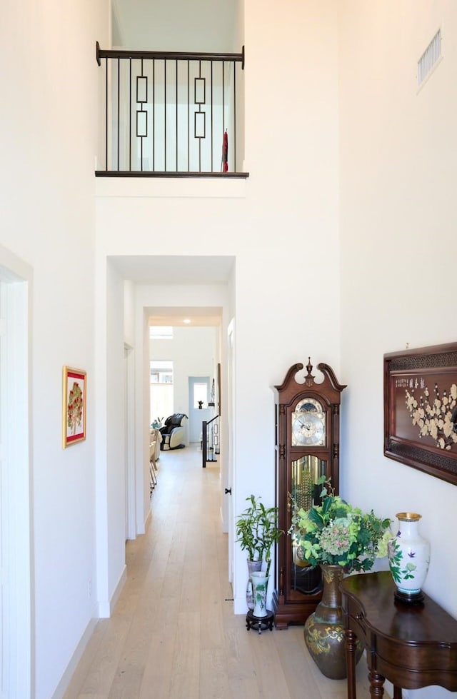 16098 Garganey Ct, Frisco, TX 75035 - corridor with wood finished floors, a towering ceiling, and baseboards