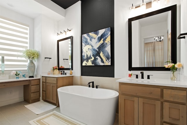 16098 Garganey Ct, Frisco, TX 75035 - bathroom with a freestanding bath, two vanities, and tile patterned flooring