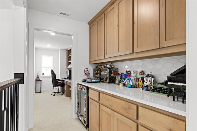16098 Garganey Ct, Frisco, TX 75035 - bar area with wine cooler, light colored carpet, built in study area, and tasteful backsplash