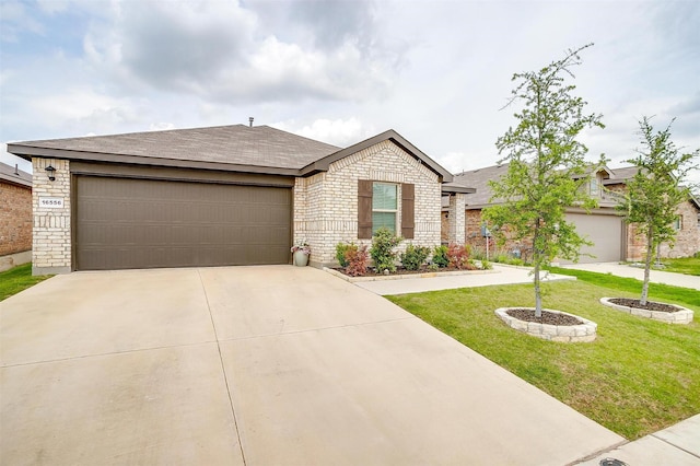 16556 White Fish Ln, Justin, TX 76247 - single story home with concrete driveway, brick siding, an attached garage, a front yard, and roof with shingles