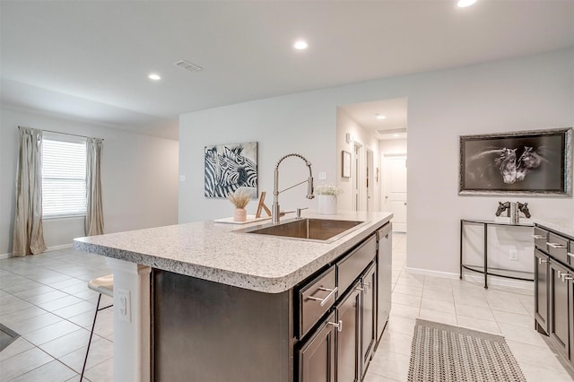 16556 White Fish Ln, Justin, TX 76247 - kitchen featuring a sink, light tile patterned floors, light countertops, a kitchen island with sink, and recessed lighting
