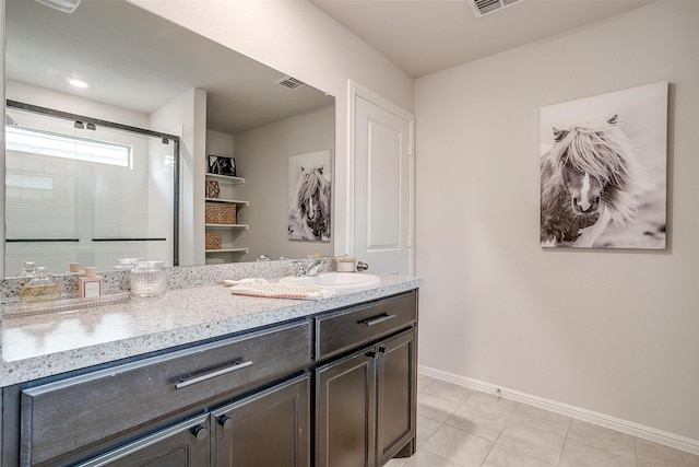 16556 White Fish Ln, Justin, TX 76247 - bathroom featuring baseboards, vanity, tiled shower, and tile patterned flooring