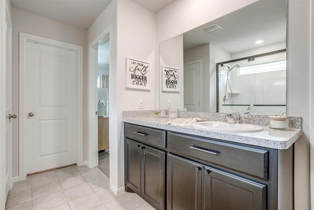 16556 White Fish Ln, Justin, TX 76247 - full bathroom featuring a stall shower, double vanity, tile patterned flooring, and baseboards