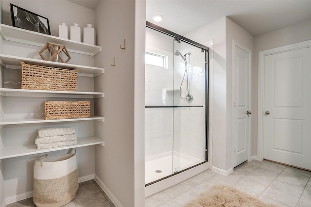 16556 White Fish Ln, Justin, TX 76247 - bathroom with a shower stall, tile patterned flooring, and baseboards