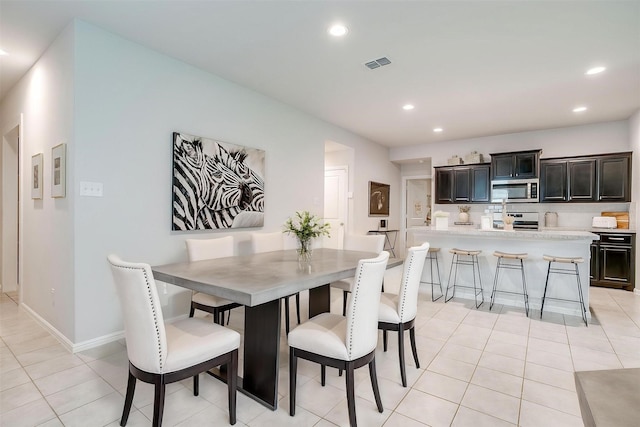 16556 White Fish Ln, Justin, TX 76247 - dining room featuring recessed lighting, light tile patterned floors, and baseboards