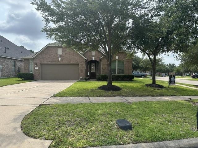 8602 Venezia Terrace Ct, Cypress, TX 77433 - view of front facade with a garage, a front yard, driveway, and brick siding