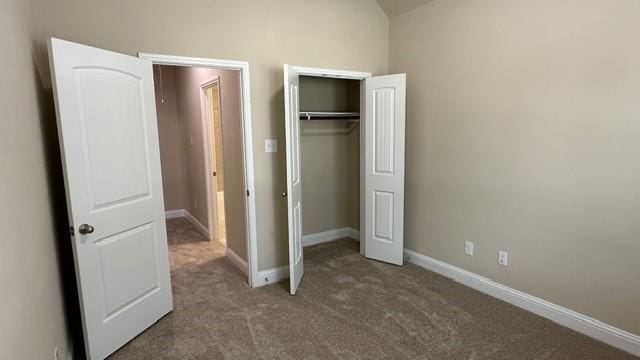 8602 Venezia Terrace Ct, Cypress, TX 77433 - unfurnished bedroom featuring carpet floors, a closet, baseboards, and vaulted ceiling