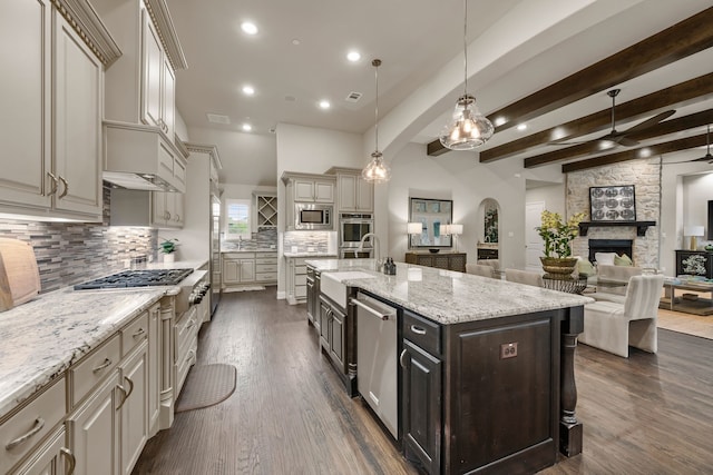 2100 Veranda Ave, Trophy Club, TX 76262 - kitchen with a ceiling fan, a sink, appliances with stainless steel finishes, a stone fireplace, and cream cabinets