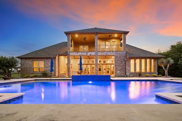 2100 Veranda Ave, Trophy Club, TX 76262 - pool at dusk with ceiling fan, an outdoor pool, and a patio