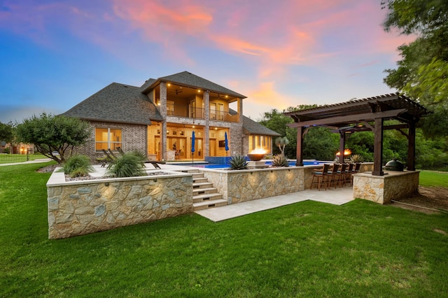 2100 Veranda Ave, Trophy Club, TX 76262 - back of property at dusk with a balcony, a lawn, a pergola, and a patio area