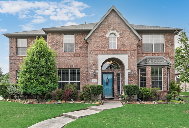 1090 Potter Ave, Rockwall, TX 75087 - view of front of home featuring brick siding, a front lawn, and a shingled roof