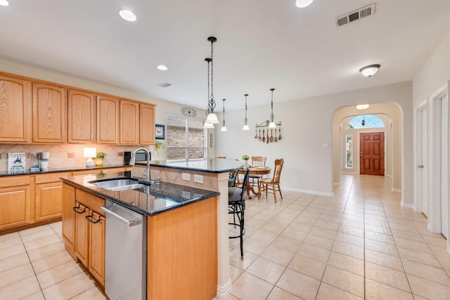 1090 Potter Ave, Rockwall, TX 75087 - kitchen with a sink, healthy amount of natural light, an island with sink, a breakfast bar area, and recessed lighting
