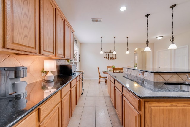 1090 Potter Ave, Rockwall, TX 75087 - kitchen featuring decorative backsplash, a sink, baseboards, dark stone countertops, and recessed lighting