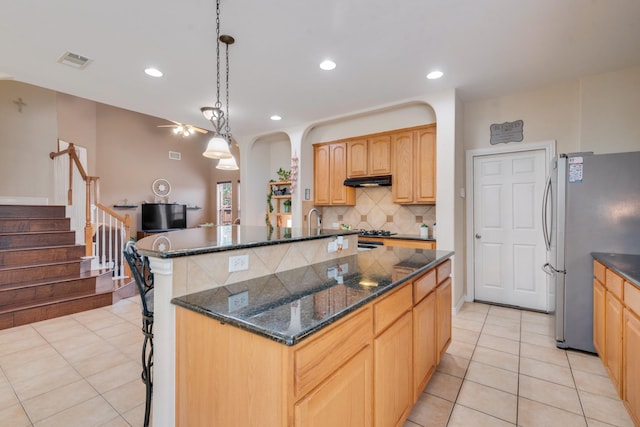 1090 Potter Ave, Rockwall, TX 75087 - kitchen featuring freestanding refrigerator, light tile patterned floors, decorative backsplash, a kitchen bar, and recessed lighting