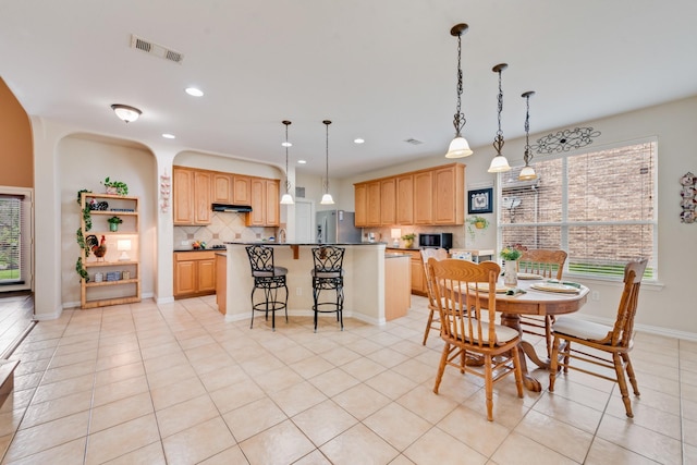 1090 Potter Ave, Rockwall, TX 75087 - dining space with recessed lighting, arched walkways, light tile patterned floors, and baseboards