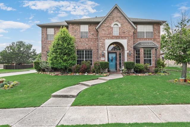 1090 Potter Ave, Rockwall, TX 75087 - view of front facade featuring brick siding, a front yard, and roof with shingles