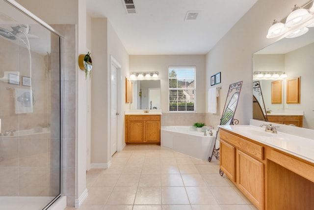1090 Potter Ave, Rockwall, TX 75087 - bathroom with a shower stall, two vanities, a bath, and tile patterned floors