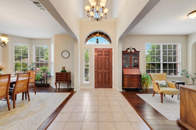 1090 Potter Ave, Rockwall, TX 75087 - tiled entrance foyer featuring a chandelier, plenty of natural light, and arched walkways