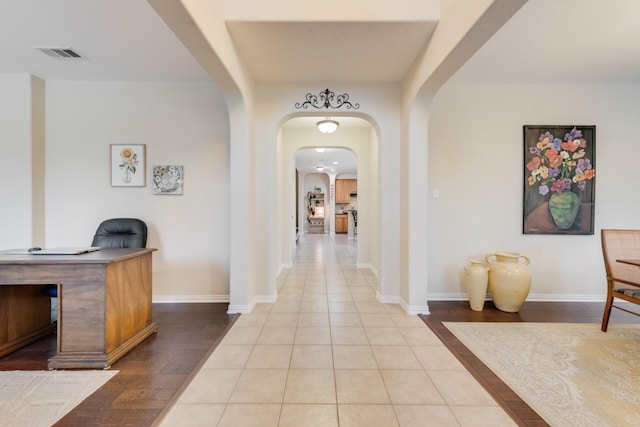 1090 Potter Ave, Rockwall, TX 75087 - hallway featuring an office area, arched walkways, baseboards, and wood finished floors