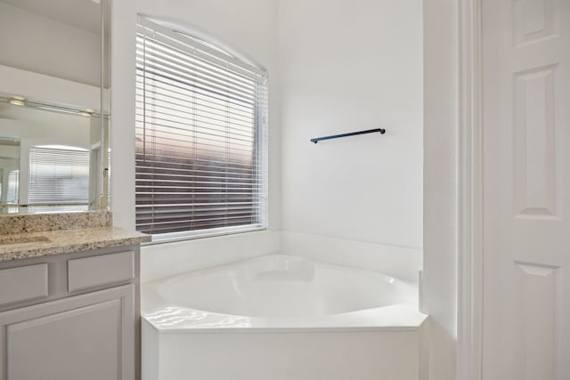 2628 Caddo Ct, Frisco, TX 75033 - bathroom featuring vanity, a bath, and plenty of natural light