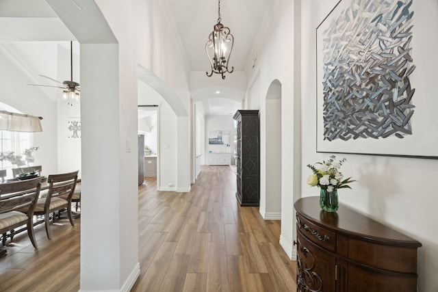 2628 Caddo Ct, Frisco, TX 75033 - hallway with arched walkways, wood finished floors, and crown molding