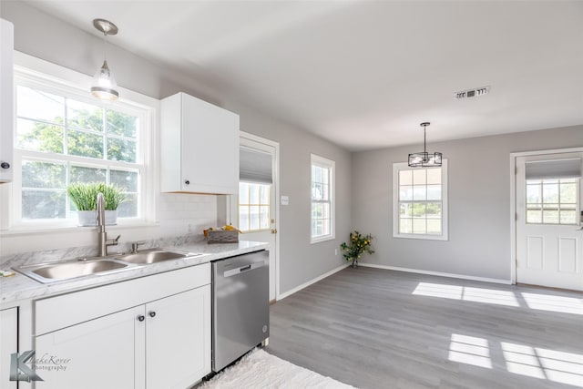 821 Cherry Ln, Clyde, TX 79510 - kitchen with dishwasher, a sink, plenty of natural light, and light countertops
