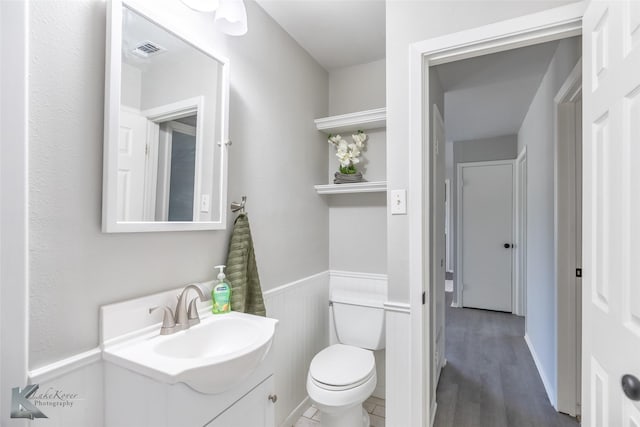 821 Cherry Ln, Clyde, TX 79510 - bathroom with vanity, toilet, and wood finished floors