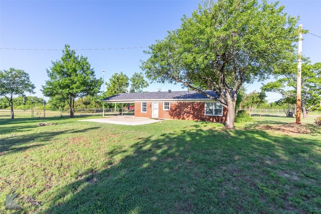 821 Cherry Ln, Clyde, TX 79510 - back of house featuring a patio area, an attached carport, and brick siding