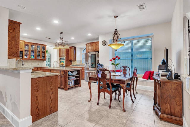 1217 Kent Brown Rd, Garland, TX 75044 - dining space featuring recessed lighting, a chandelier, light tile patterned floors, and baseboards