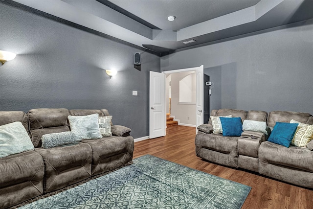 1217 Kent Brown Rd, Garland, TX 75044 - living room featuring wood finished floors, a raised ceiling, stairs, and baseboards