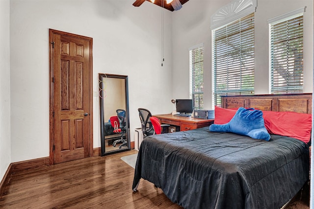 1217 Kent Brown Rd, Garland, TX 75044 - bedroom featuring wood finished floors, a ceiling fan, baseboards, and a high ceiling