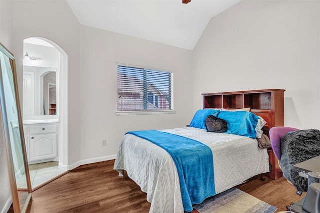 1217 Kent Brown Rd, Garland, TX 75044 - bedroom with lofted ceiling, wood finished floors, arched walkways, and baseboards